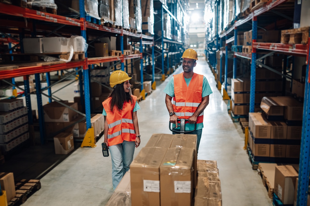 Warehouse workers transporting goods on a pallet