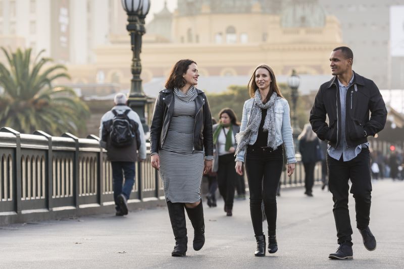People walking across a bridge