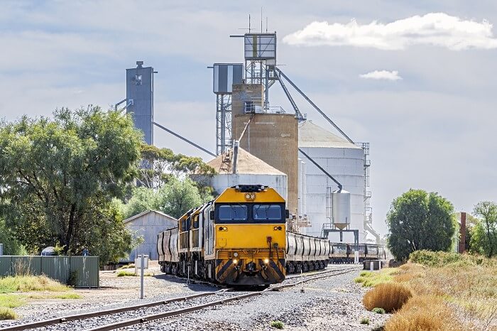 Freight Train Carrying Grain Leaving A Grain Silo In Victoria