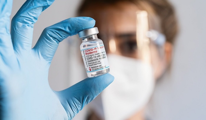 Stock photo of scientist with mRNA vial